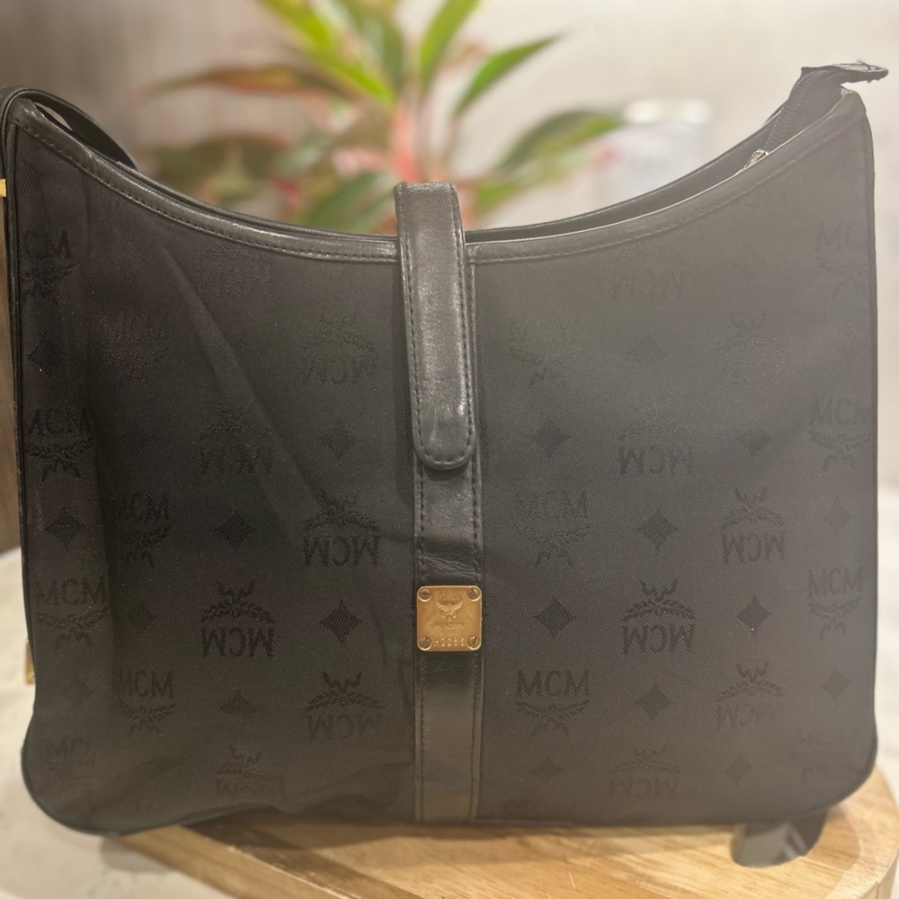 MCM Black and Gold Crossbody Bag with Crescent Shape and Leather Strap